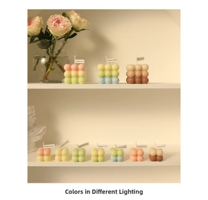 Detailed close-up of pastel bubble cube candles in various sizes on a decorative shelf