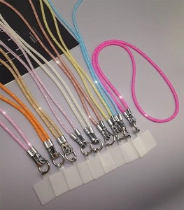 Detail view of colorful glitter phone lanyards with silver hooks and clear patches