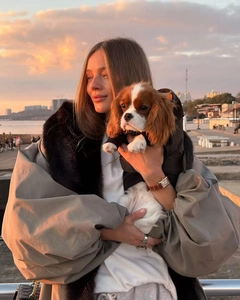 Dettaglio di un parka invernale beige oversize con un grande collo in ecopelliccia nera
