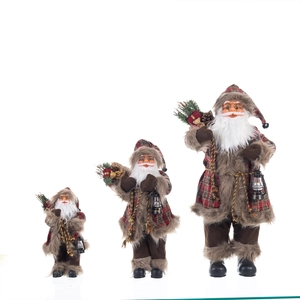 Set of three standing Santa Claus figurines in various sizes with festive accessories
