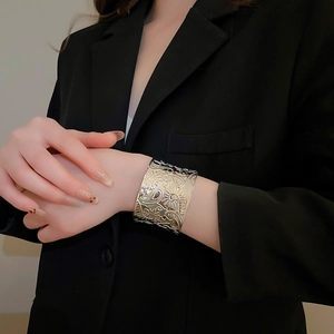 Detailed macro view of vintage silver cuff bracelet with intricate embossed floral patterns