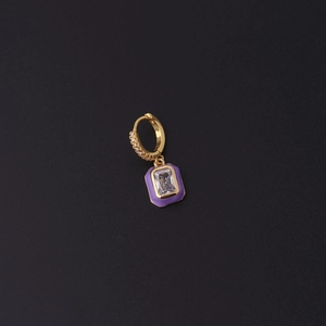 Macro shot of gold hoop earring featuring purple enamel and rectangle zircon drop detail