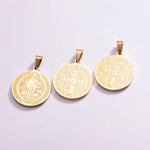 Three gold Saint Benedict medal pendants in stainless steel with laser-etched religious symbols