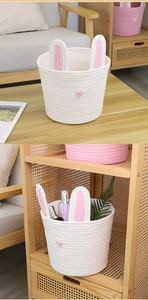 Detailed macro view of woven cotton rope bunny storage basket with pink ear lining