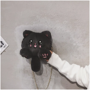 Detail of cute black plush cat bag with soft pink paws and premium gold chain strap