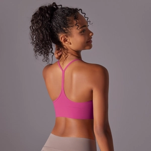 Detail view of the rose pink racerback sports bra with moisture-wicking stretch fabric