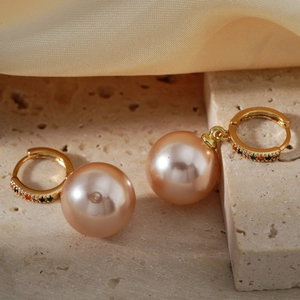 Elegant champagne pearl hoop earrings with colorful gemstones on a gold metal band