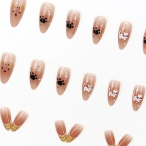 Caramel brown almond press-on nails with cute cat paw prints and star designs