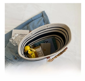 Top view of spacious woven tote bag interior showing bamboo handle and daily essentials