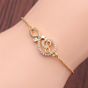 Detailed view of infinity symbol gold bracelet with star charm and pave cubic zirconia
