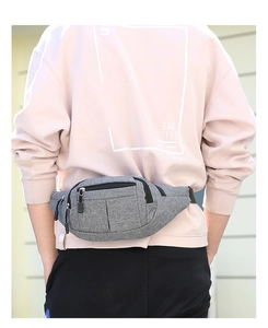 Macro view of grey textured sports waist bag showing multi-layered zippers and durable fabric