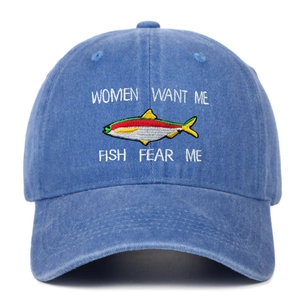 Close-up of blue washed denim baseball cap with funny fishing embroidery and color fish