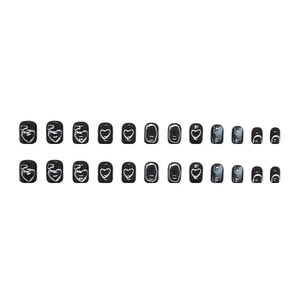 Detail of 24pcs glossy black press-on nails with white abstract heart and line patterns