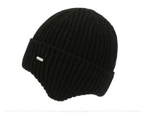 Detailed side view of black ribbed knit beanie featuring an elegant metallic logo plaque
