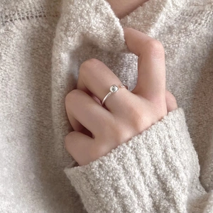 Minimalist 925 sterling silver bean bead open ring worn on model with soft lighting
