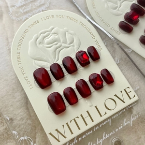 Handmade burgundy cat eye press-on nails with red square gemstone decoration