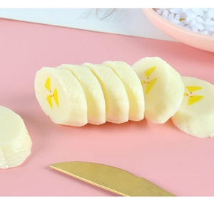 Macro view of realistic PVC banana slice charms for DIY crafts and keychains