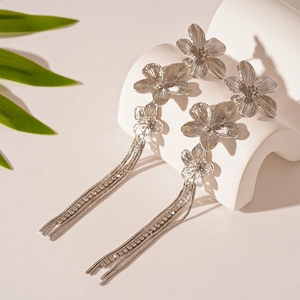 Silver flower tassel drop earrings with sparkling rhinestones and metallic finish
