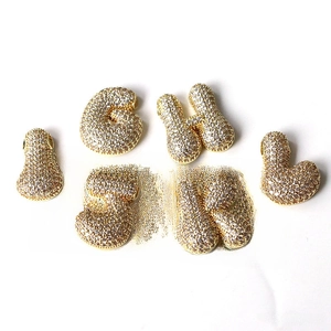 Detail of gold bubble letter pendants G to L with shimmering micro-pave white zircon stones