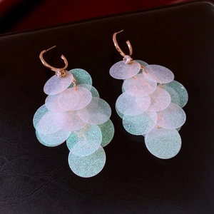 Detail of C-shaped drop earrings with iridescent sequins and sparkling zircon accents