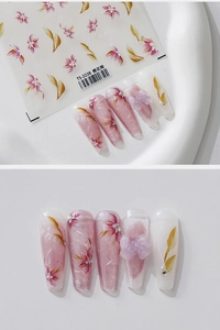 Detail of floral nail stickers with 3D purple bows, pearls, and rhinestones