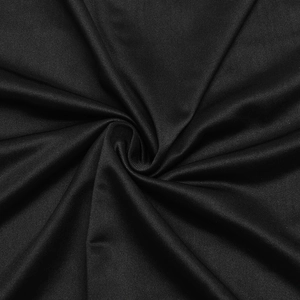 Detailed macro view of black ribbed fabric texture with elegant spiral folding shadows