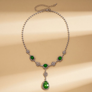 Vintage palace style silver necklace with green oval gems and teardrop pendant decoration