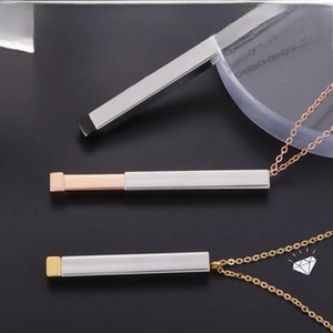 Detailed view of telescopic bar pendants in silver, rose gold, and gold on link chains