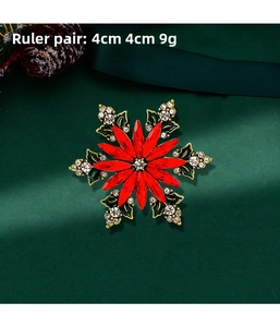 Detail of red and green snowflake Christmas brooch with rhinestones, size 4cm x 4cm