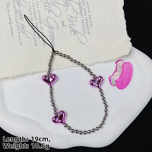 Detail of 19cm beaded phone strap with silver beads and metallic pink heart charms
