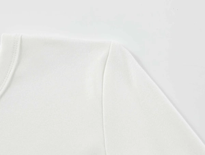 Close-up of white modal athletic shirt showing refined shoulder stitching and fabric texture