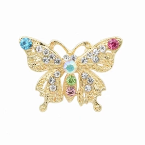 Detailed macro view of golden butterfly brooch with colorful rhinestones and hollow design