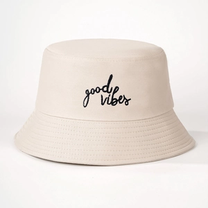 Minimalist cream cotton bucket hat with black Good Vibes embroidery on a white background