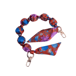 Short hand strap for bags with floral fabric beads and gold metal spring clasps