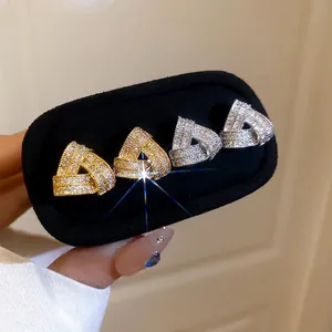 Sparkling triangle stud earrings in gold and silver finish with pave-set zircon crystals