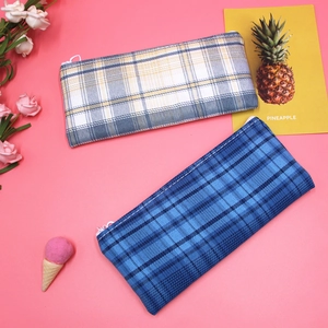 Detail view of large capacity plaid canvas pencil bags with secure white zipper closure