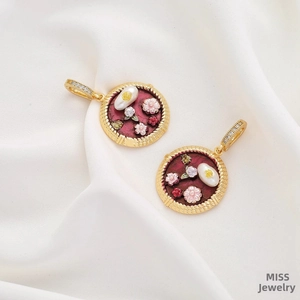 Detail of oil painting style flower pendant with vintage pearls on white silk