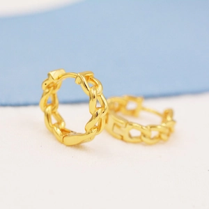 Detailed view of golden link chain hoop earrings with a polished textured finish