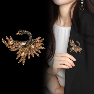 Elegant swan brooch featuring brown crystals on a gold-plated base for women's suits