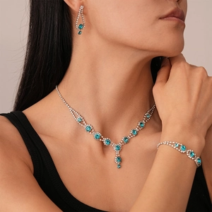 Elegant 3-piece silver jewelry set with sky blue round crystals on Asian model
