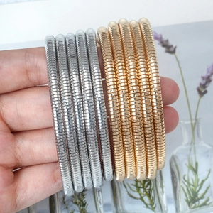 Minimalist stackable coil spring bracelets in gold and silver finish for women