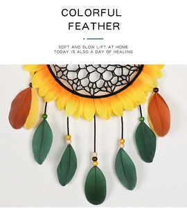 Detail of sunflower center design on dreamcatcher with colorful feathers and beads