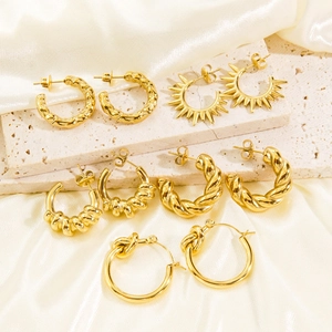 Five pairs of assorted 14K gold-plated C-shaped hoop earrings with textured patterns