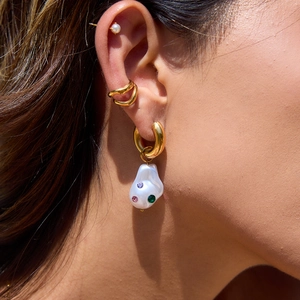 Golden titanium steel hoop earrings featuring baroque pearls and colored gemstones