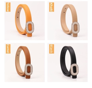 Detail of four thin belts in yellow, khaki, camel, and black with pearl buckle