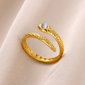 Detailed view of golden snake-shaped ring with scales and grey gemstone inlay