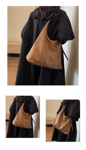 Detailed view of the soft brown PU leather tote bag shown on a model's shoulder