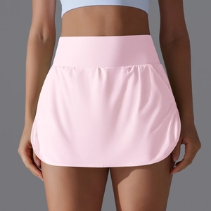 Detail of high-waisted pink tennis skort showing supportive waistband and athletic cut