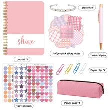 Flat lay of pink DIY stationery set including journal, stickers, and pencil case details