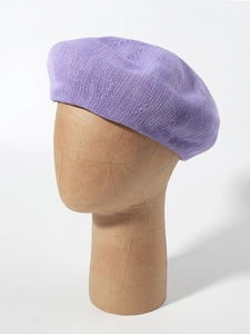Detailed knit texture of breathable purple linen beret on a display head mannequin